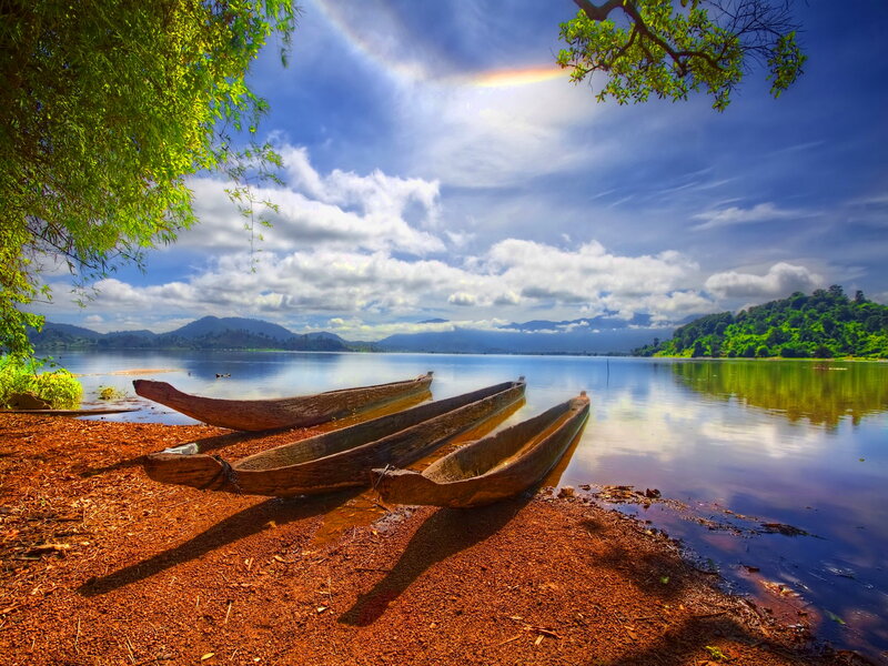 Wooden Canoes on Shore — Blue