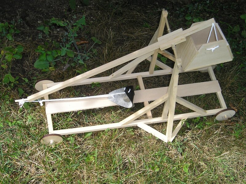 Wooden catapult model on grass