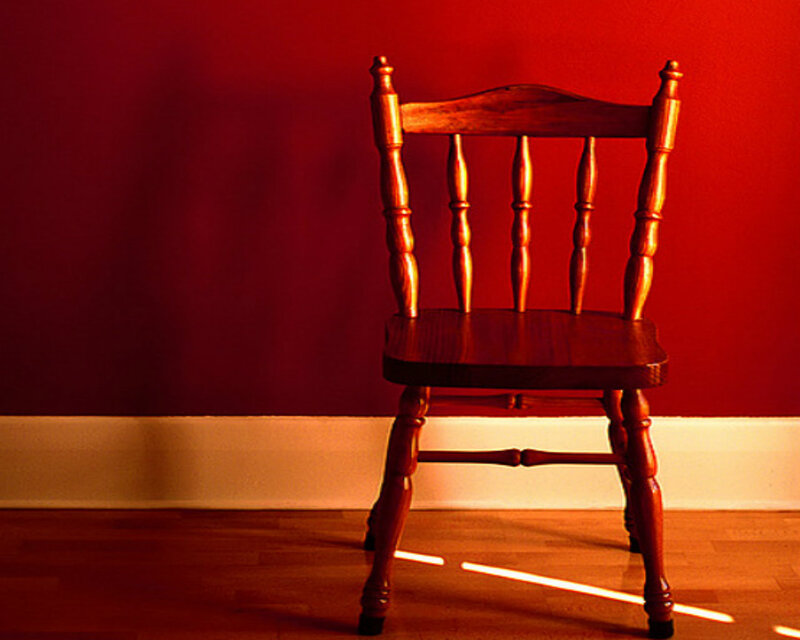 Wooden Chair Against Red Wall