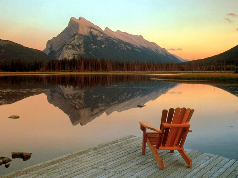 Wooden chair by a mountain lake