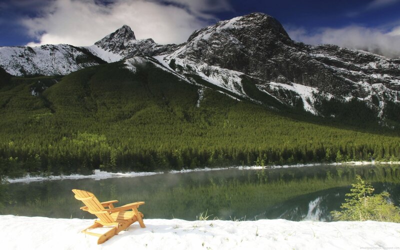 Wooden chair by a mountain lake