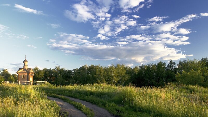 Wooden chapel in a green field