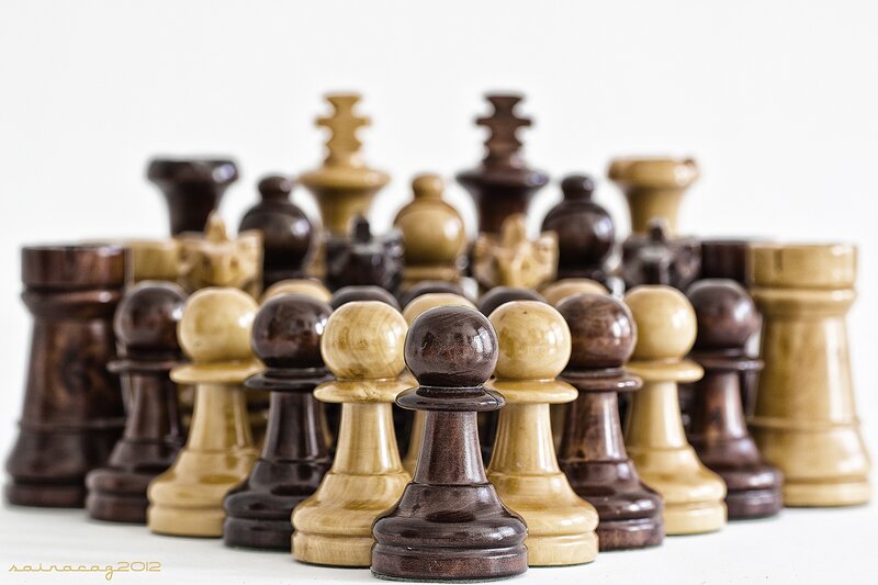 Wooden chess pieces in focus