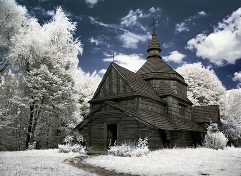 Wooden church in snowy forest