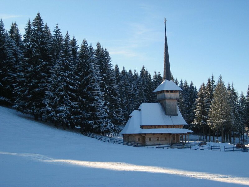 Wooden church in snowy forest