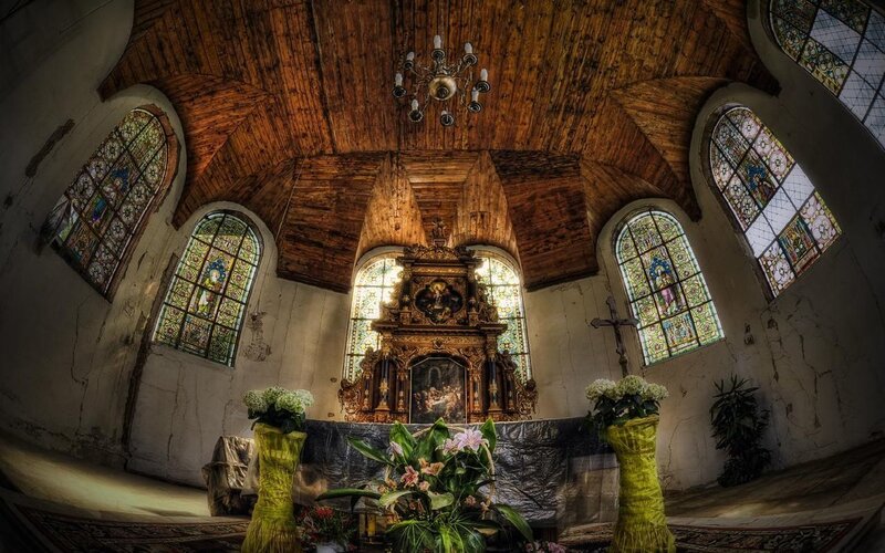 Wooden church interior with stained glass