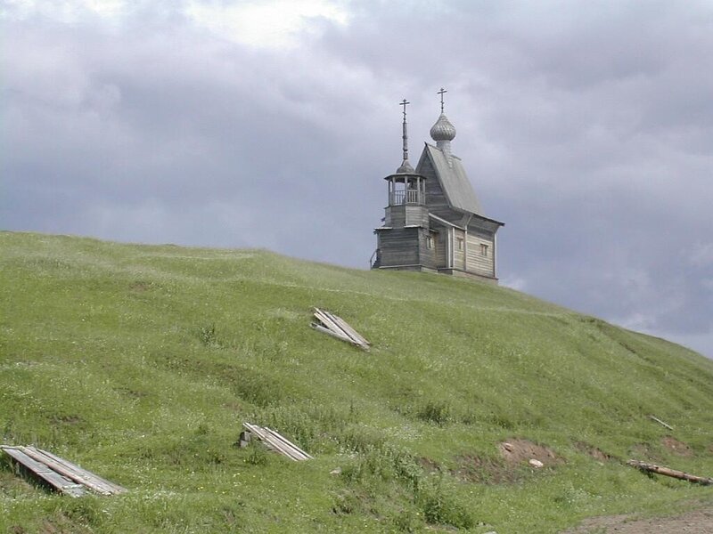 Wooden church on a grassy hill