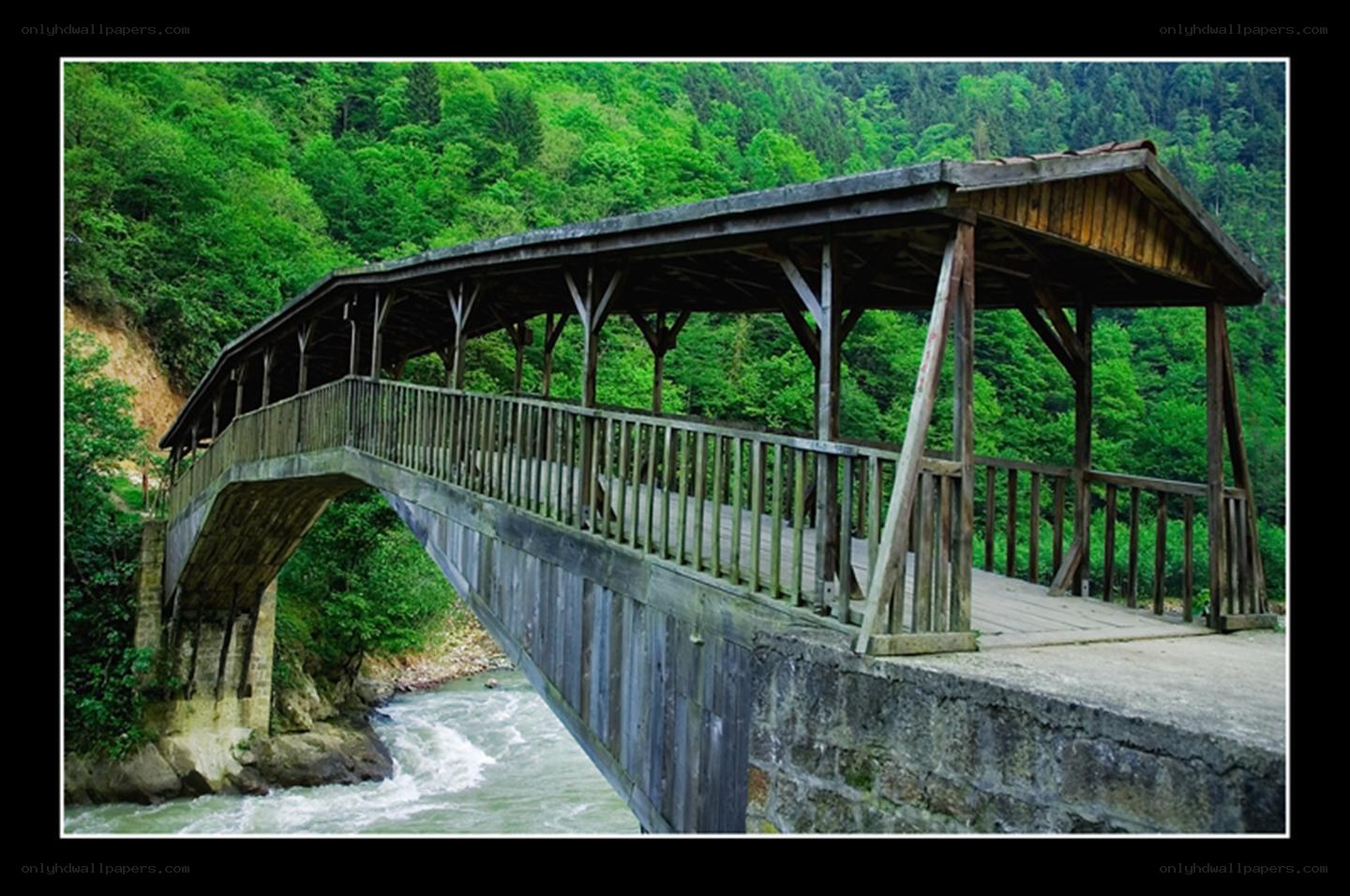 Wooden covered bridge over river