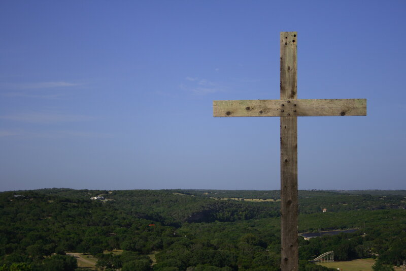 Wooden cross overlooking hills