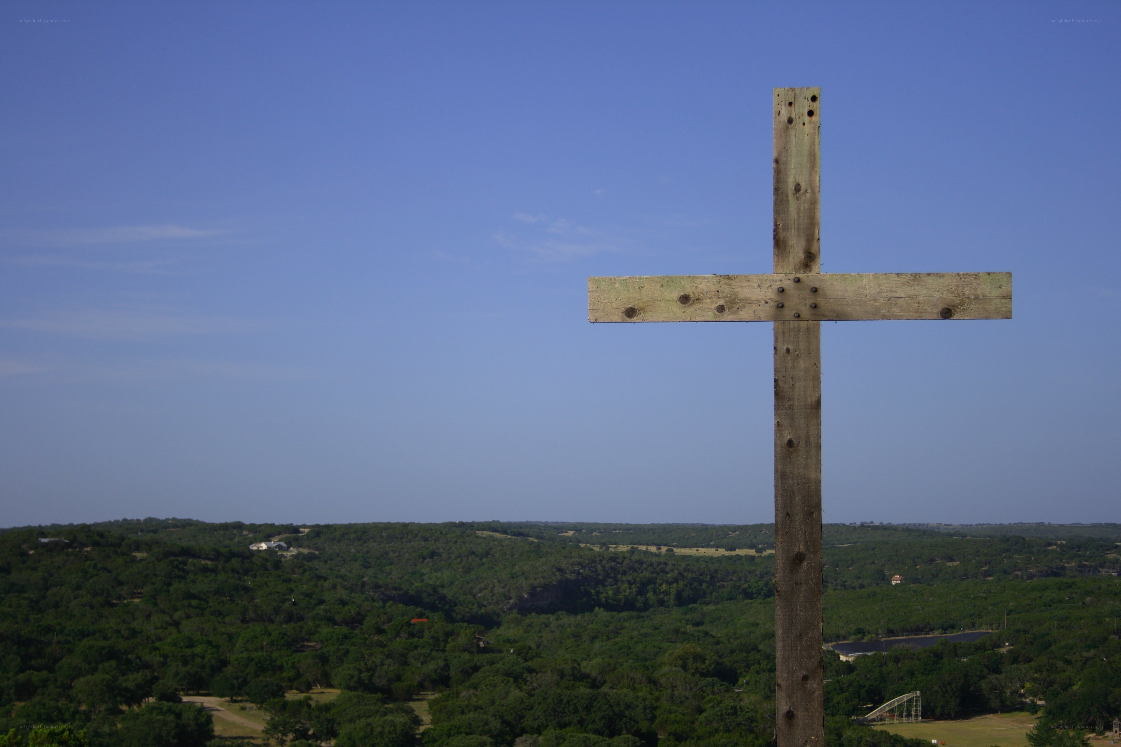 Wooden cross overlooking hills