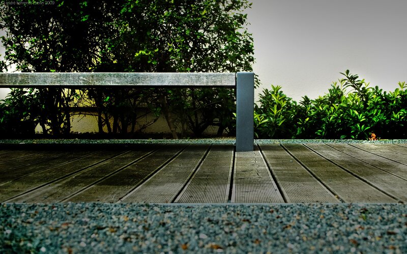 Wooden deck with bench and greenery
