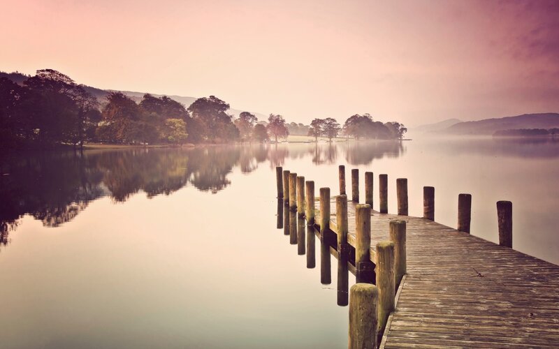 Wooden dock at dawn on a calm lake