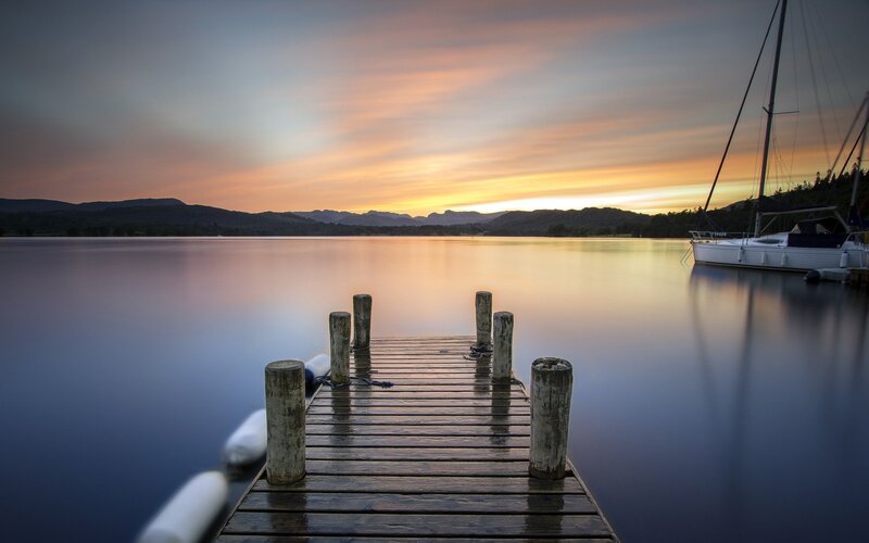 Wooden Dock at Sunset — Blue, Serene, Photograph, Sailboat, Mountains