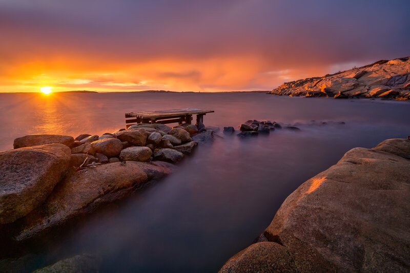 Wooden Dock at Sunset — Orange, Serene, Photograph, Sun, Rocks