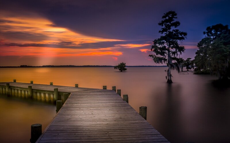 Wooden Dock at Sunset — Orange, Serene, Photograph, Tree