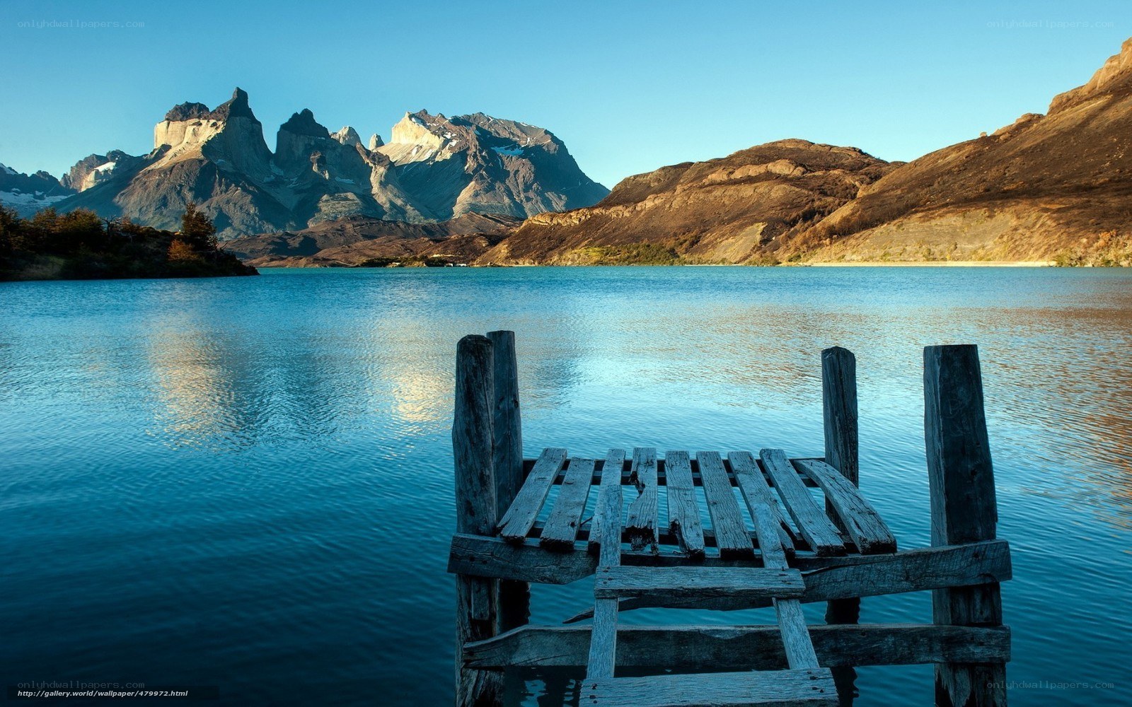 Wooden dock by mountain lake