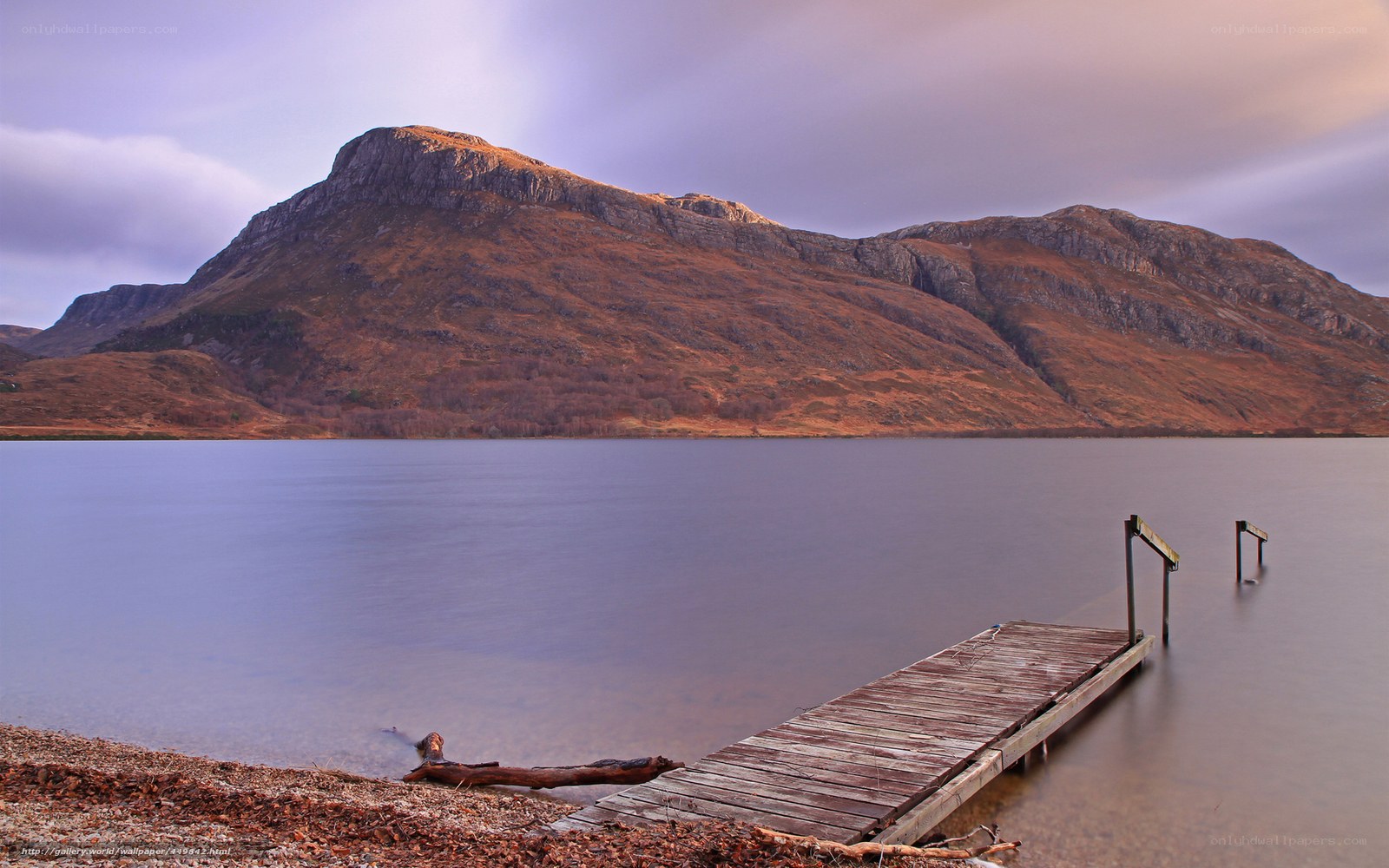 Wooden dock by mountain lake