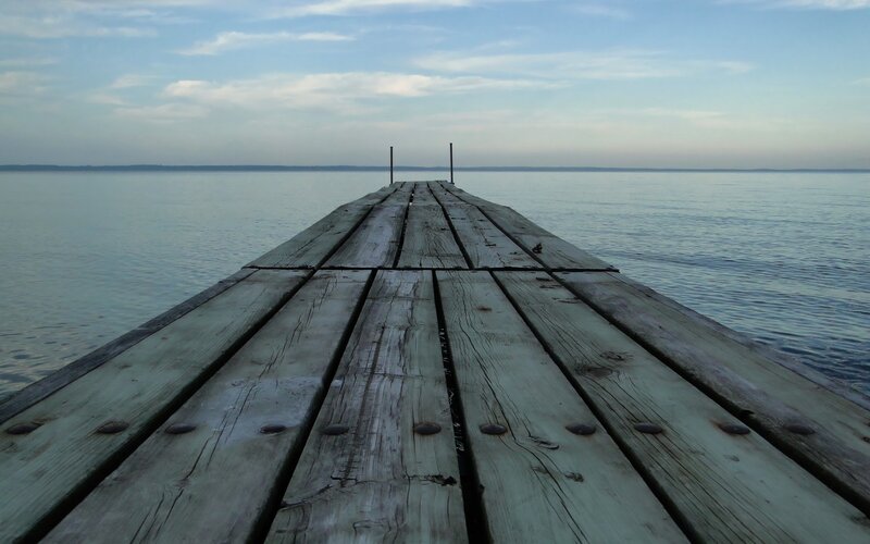 Wooden dock extending into calm water