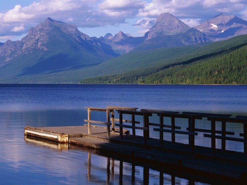 Wooden dock on a lake with mountains