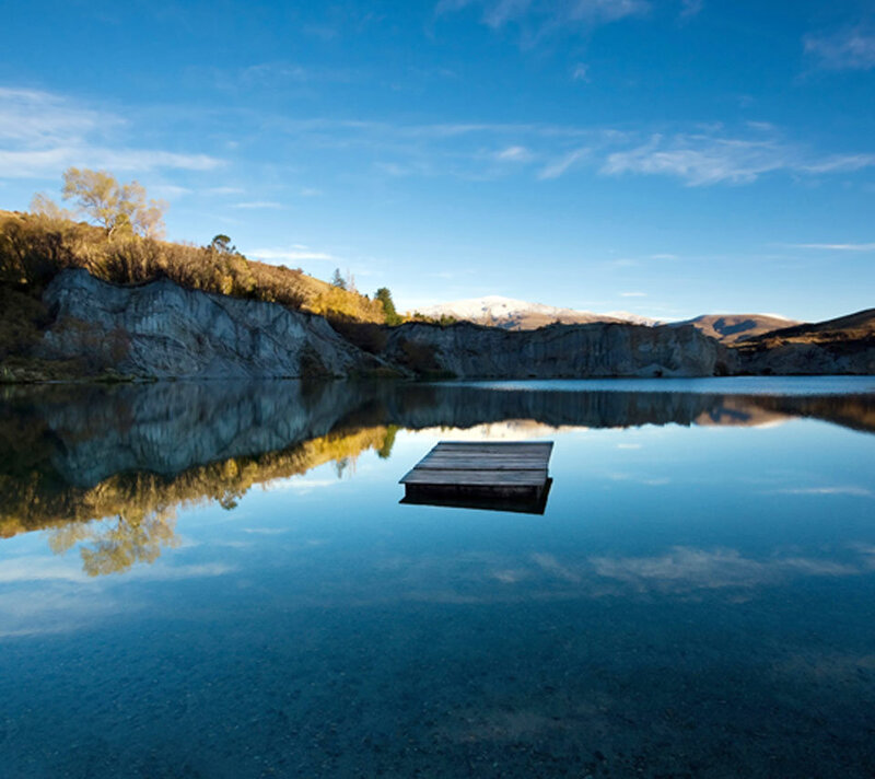 Wooden Dock on Lake — Blue, Serene, Afternoon, Photograph, Cliffs