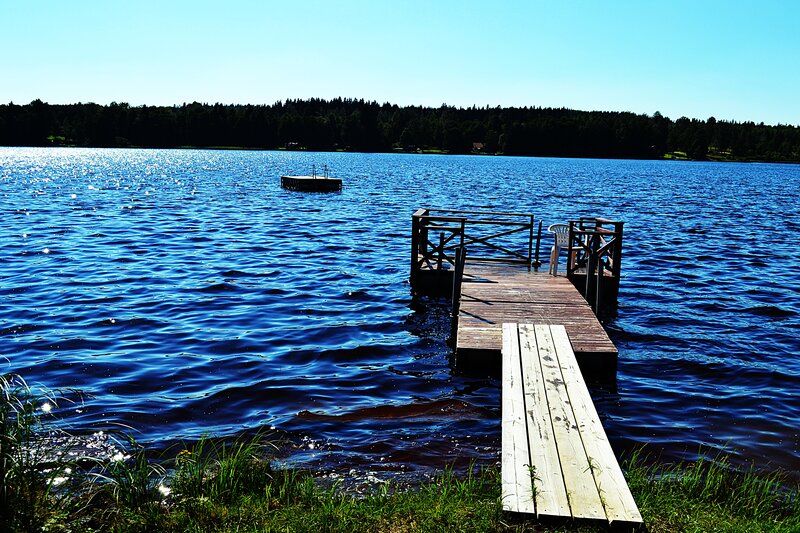 Wooden Dock on Lake — Blue, Serene, Afternoon, Photograph, Trees, Chair