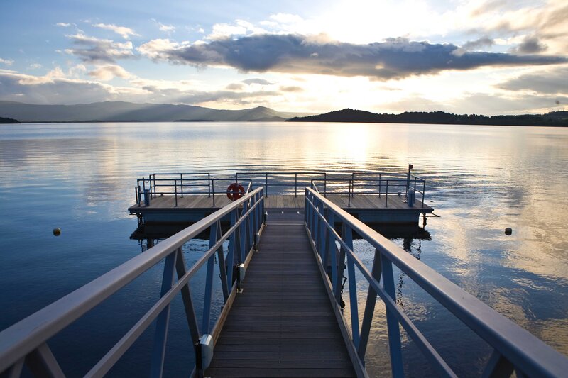 Wooden Dock on Lake — Blue, Serene, Sunset, Photograph, Mountains, Life Preserver