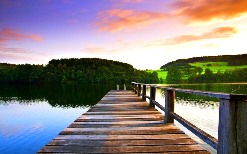 Wooden Dock on Lake — Blue, Serene, Sunset, Photograph, Trees, Sky