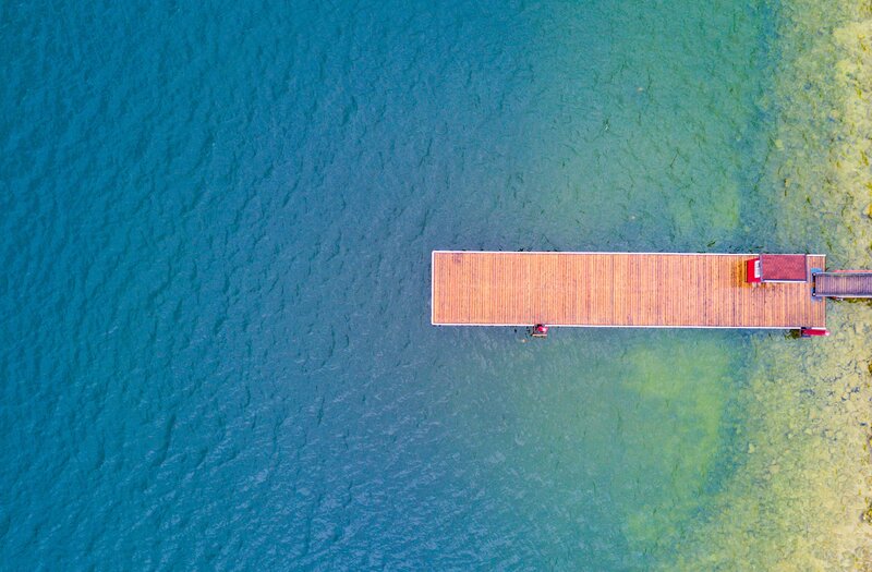 Wooden Dock on Water — Blue, Serene, Afternoon