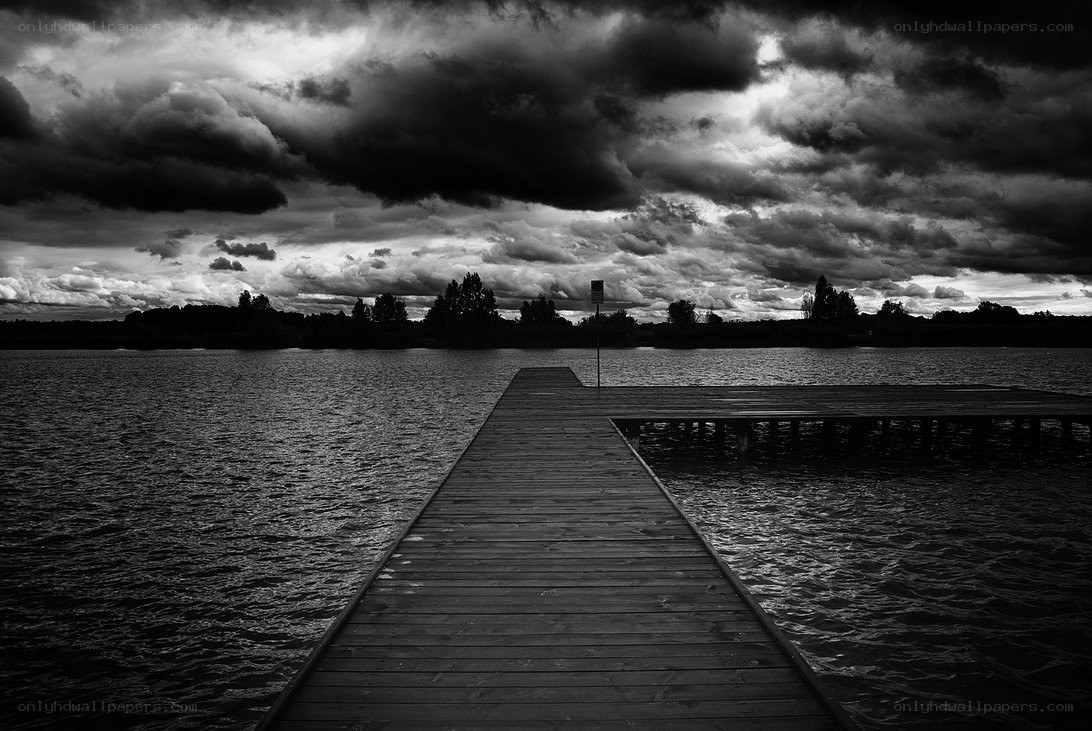 Wooden dock under stormy sky