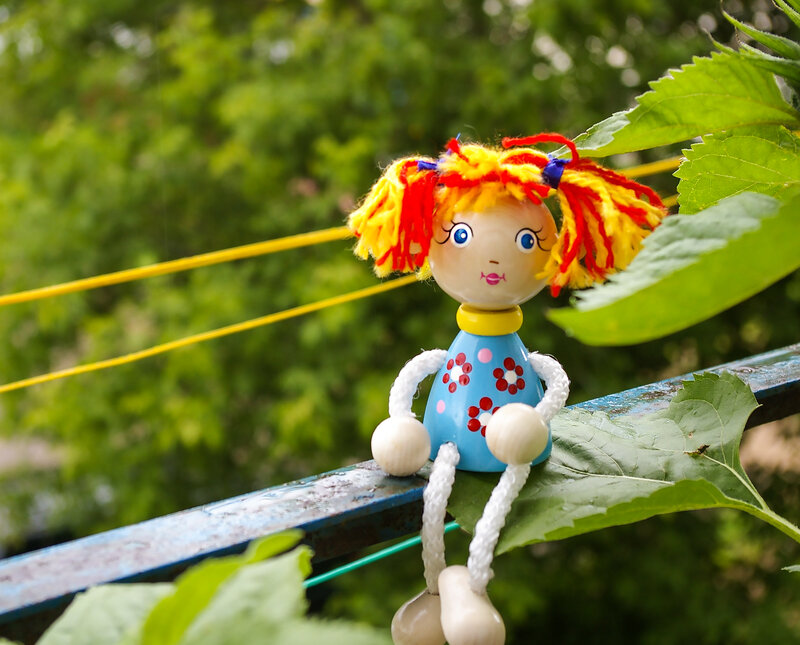Wooden Doll on Railing