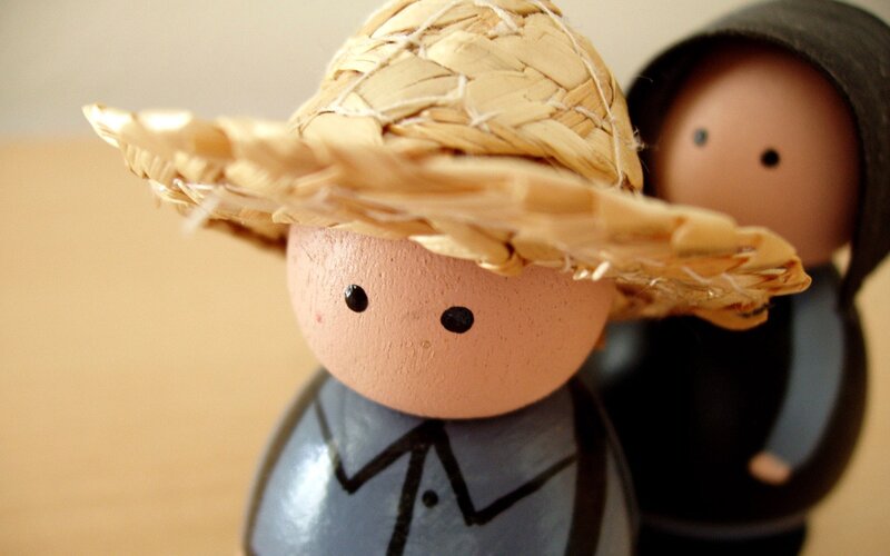 Wooden dolls with straw hat