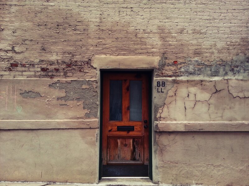 Wooden Door in Brick Wall