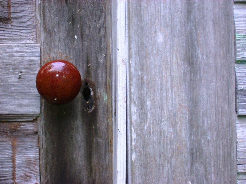 wooden door with red knob