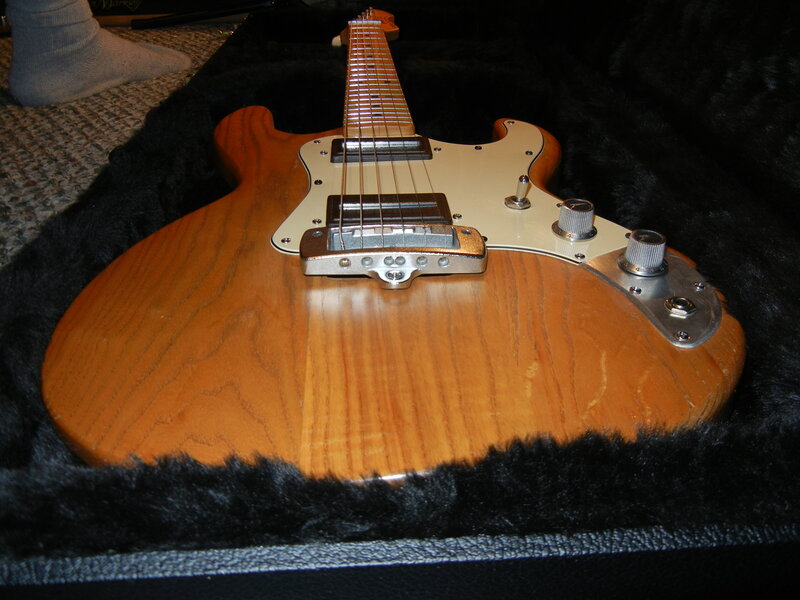 wooden electric guitar in case