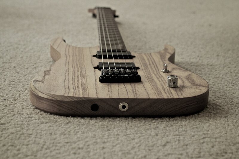 wooden electric guitar on carpet
