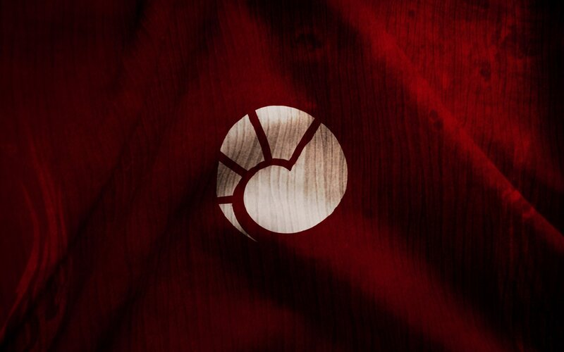 Wooden Emblem on Red Fabric