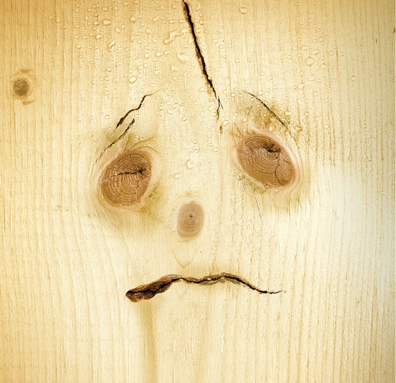 Wooden Face with Water Droplets