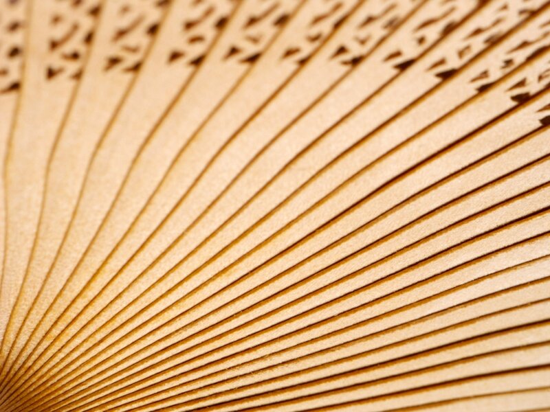 wooden fan with intricate cutouts