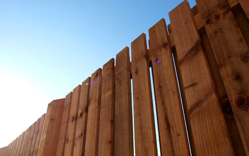 Wooden fence against blue sky