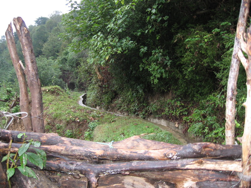 wooden fence by a stream