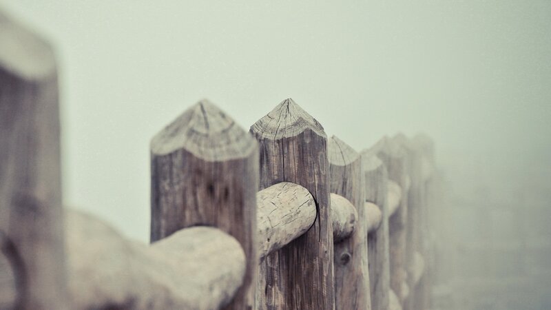wooden fence in fog