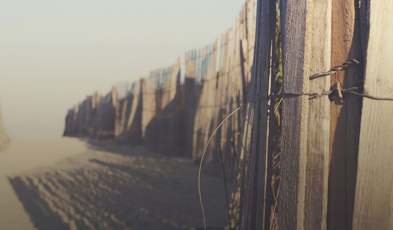 Wooden fence on a sandy beach
