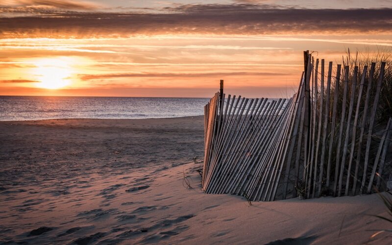 Wooden Fence on Beach — Orange, Serene, Sunset, Photograph