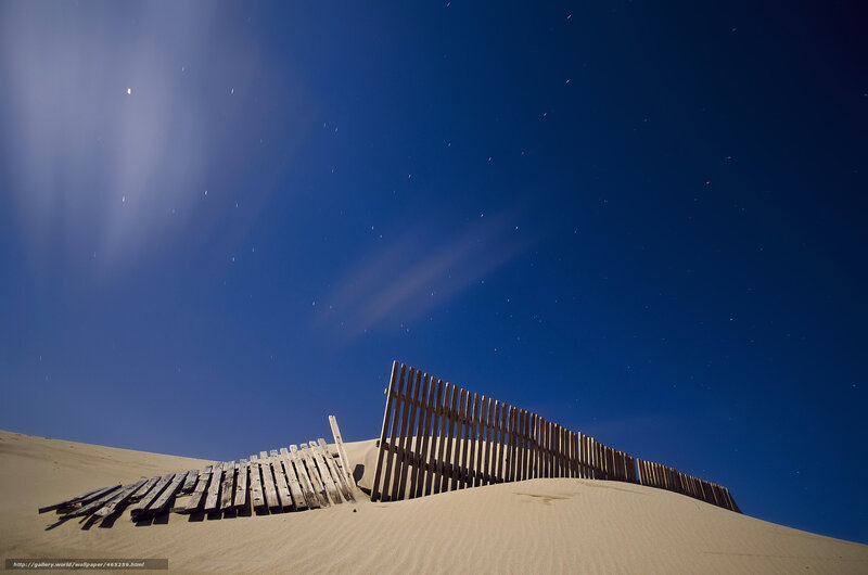 Wooden fence on sand dune