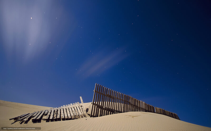 Wooden fence on sand dune