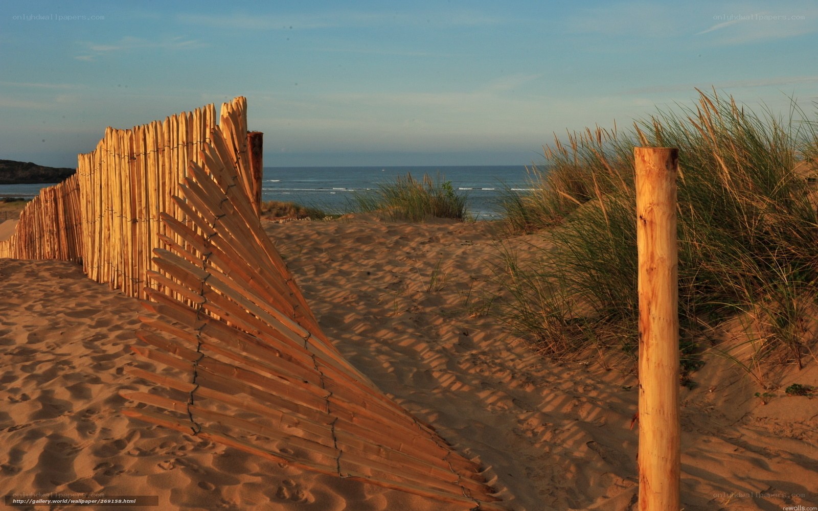 Wooden fence on sandy dune