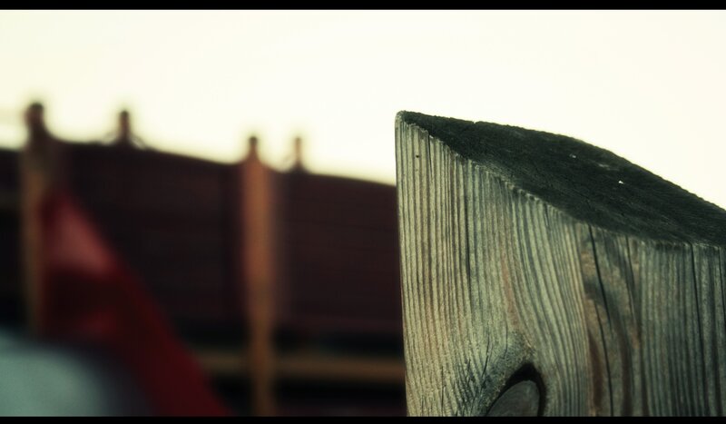 wooden fence post in focus