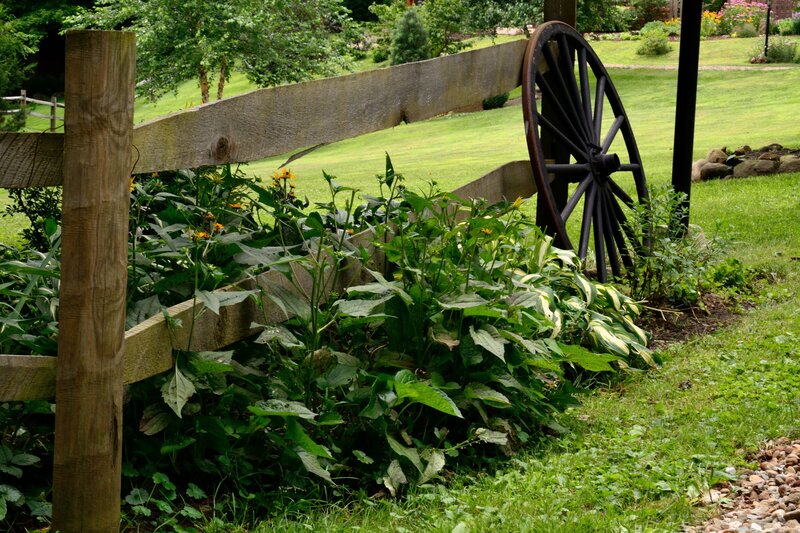 Wooden Fence with Wagon Wheel