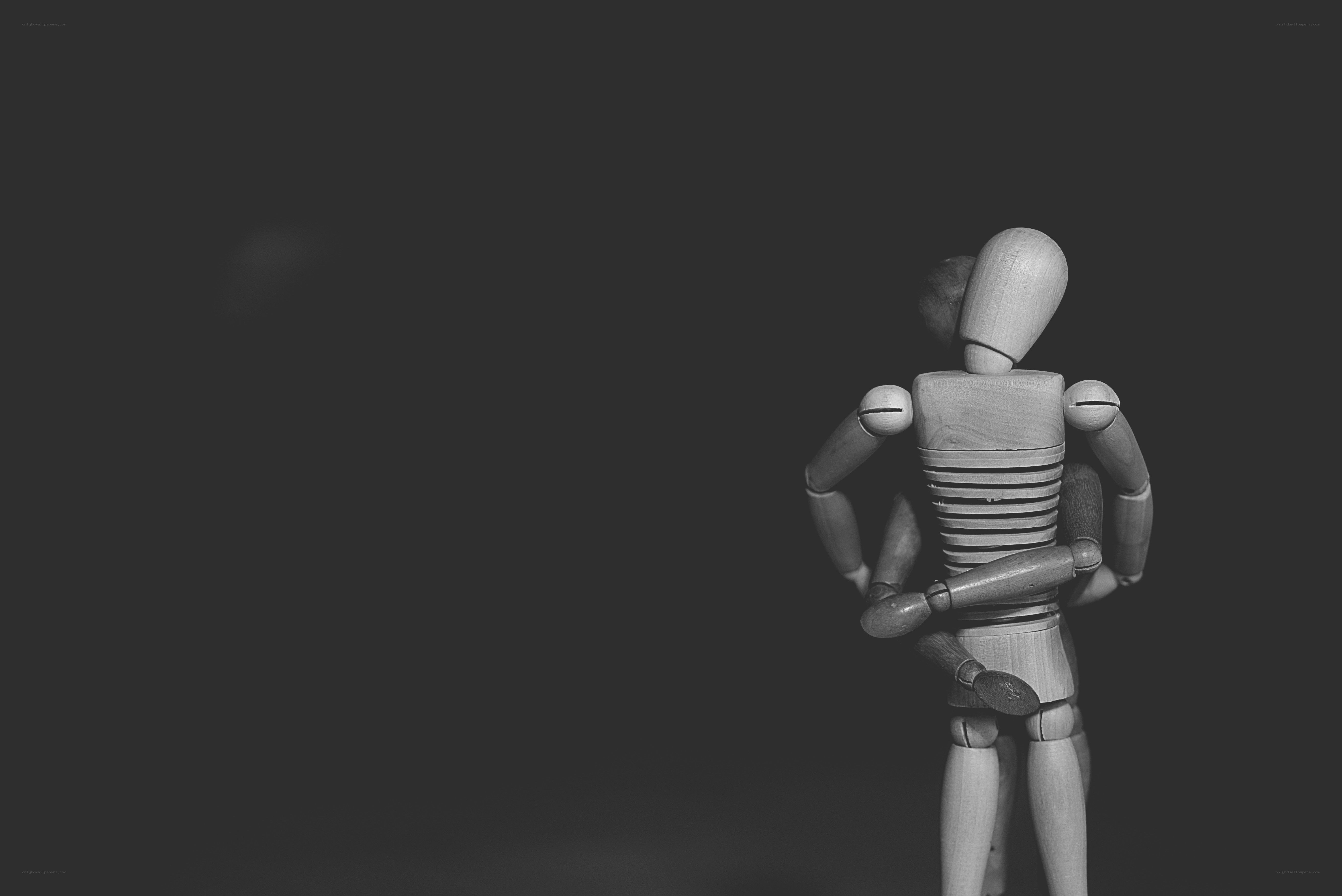 Wooden figures embracing
