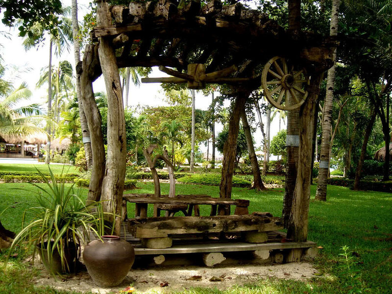 Wooden gazebo in tropical garden